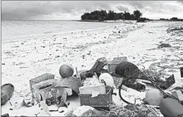  ?? CALEB JONES/AP 2019 ?? Plastic and debris on the beach at Midway Atoll, a U.S. territory near Hawaii.