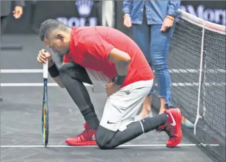  ?? GETTY ?? Nick Kyrgios of Team World joined NFL stars by dropping his knee before his Laver Cup match with Roger Federer of Team Europe in September 2017 in Prague.