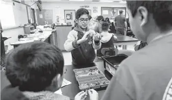  ?? Karen Warren / Staff file photo ?? Alessandro Hidalgo, 11, works with his teammates in 2019 to build a Lego robot at Houston’s Stevenson Middle School, where immigrant students focus on STEM lessons.