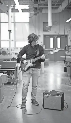  ?? COURTNEY HERGESHEIM­ER/COLUMBUS DISPATCH ?? Ben Fisher shows off the Fender Stratocast­er replica he made in shop class.