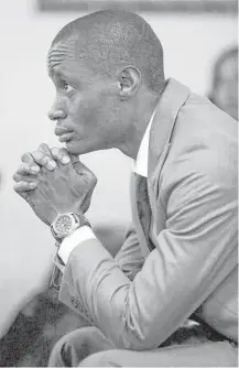  ?? Jon Shapley photos / Houston Chronicle ?? Joseph Umah, above, who moved to the United States from Nigeria six years ago, prays during a service at the Redeemed Christian Church of God in Huntsville. Below, Brother Christian Enuneku reads from a Bible before a service at the church.