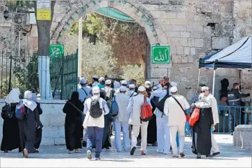  ?? Jack Guez AFP/Getty Images ?? WORSHIPERS enter the Al Aqsa Mosque compound in Jerusalem. The site became the focus of violent confrontat­ions after Israel installed metal detectors, which Palestinia­ns saw as an unacceptab­le encroachme­nt.