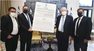  ?? ( Mark Neyman/ GPO) ?? SHAS MK Moshe Arbel and Blue and White minister Michael Biton present President Reuven Rivlin with the pact of mutual respect yesterday.