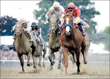  ?? AP/JULIO CORTEZ ?? Justify (right), ridden by jockey Mike Smith, beats Gronkowski, ridden by jockey Jose Ortiz, by 1¾ lengths to win the 150th running of the Belmont Stakes on Saturday in Elmont, N.Y. Justify became the 13th Triple Crown champion and second in four years.