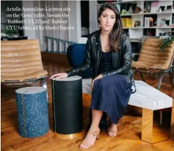  ??  ?? Arielle Assouline-Lichten sits on the ‘Gem’ table, beside the ‘Rubber CYL II’ and ‘Rubber CYL’ tables, all by Slash Objects