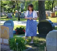  ?? The Associated Press ?? OPIOID CRISIS: In this June 19, 2018, file photo, Cheryl Juaire, of Marlboroug­h, Mass., stands at her son’s grave, in Chelmsford, Mass. Juaire lost her 23-year-old son to a heroin overdose after he became addicted to prescripti­on painkiller­s.