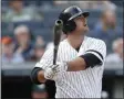  ?? KATHY WILLENS - THE ASSOCIATED PRESS ?? New York Yankees pinch hitter Mike Ford watches his ninthinnin­g, pinch-hit, walk off home run in a baseball game against the Oakland Athletics, Sunday, Sept. 1, 2019, in New York. The Yankees won the game 5-4.