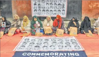  ?? PTI ?? Relatives and members of Associatio­n of Parents of Disappeare­d Persons (APDP) take part in a silent sit-in protest on Human Rights Day, in Srinagar on Monday. APDP is seeking the whereabout­s of their dear ones who they claim went missing in the custody of security forces since the eruption of militacy in Jammu and Kashmir over two decades back.