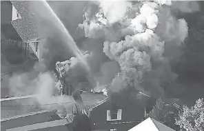  ??  ?? Flames consume a house Thursday in Lawrence, Mass., a suburb north of Boston, amid a series of natural gas explosions that burned at least 39 homes. WCVB VIA AP