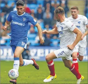  ?? Picture: Andy Jones ?? Gills striker Conor Wilkinson tracked by Portsmouth on Sunday