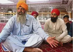  ?? — AP ?? Hoping for peace: Radesh (left) speaking at a temple in Peshawar.