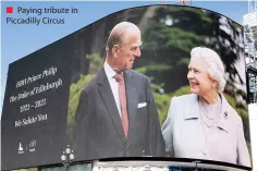  ??  ?? ■ Paying tribute in Piccadilly Circus