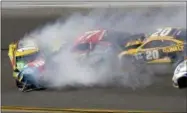  ?? DARRYL GRAHAM — THE ASSOCIATED PRESS ?? Erik Jones (77) and Matt Kenseth (20) collide with Kyle Busch (18) during the NASCAR Daytona 500 auto race at Daytona Internatio­nal Speedway in Daytona Beach, Fla., Sunday.