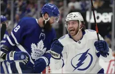  ?? FRANK GUNN — THE CANADIAN PRESS VIA AP ?? Lightning center Brayden Point, right, celebrates his goal in front of Maple Leafs defenseman Jake Muzzin during Game 2 on Wednesday night.