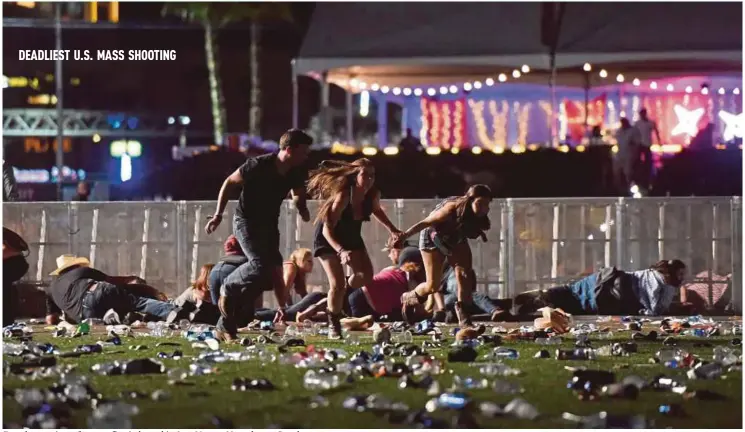  ??  ?? People running after gunfire is heard in Las Vegas, Nevada, on Sunday.