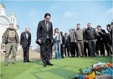  ?? THE ASSOCIATED PRESS ?? Japanese Prime Minister Fumio Kishida, centre, offers prayers, at a church in Bucha, a town outside Kyiv that became a symbol of Russian atrocities against civilians, on Tuesday.