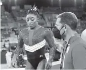  ?? WALLY SKALIJ TNS ?? Simone Biles is consoled after an uncharacte­ristically poor vault: ‘I had no idea where I was in the air,’ she said.