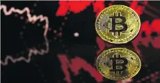  ?? LUKE MACGREGOR/BLOOMBERG FILES ?? Bitcoin plunged as much as 4.6 per cent Tuesday to US$6,450.01, bringing the slide for the year to more than 50 per cent. In 2017, it had seen a surge of more than 1,400 per cent.