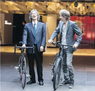  ?? CHRISTINNE MUSCHI ?? Kent Nagano, left, and Emmanuel Bilodeau arrive by bike for the announceme­nt of the OSM’s summer season at Place des Arts on Wednesday. Bilodeau will host several outdoor OSM events.