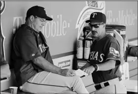  ?? JAE C. HONG / ASSOCIATED PRESS (2015) ?? Texas Rangers pitching coach Mike Maddux, right, and brother Greg Maddux, are working together during spring training in Arizona. Greg Maddux, a Hall of Famer, is a graduate of Valley High School, while Mike Maddux graduated from Rancho High School.