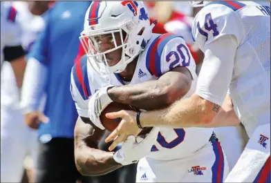  ?? Tom Morris/Louisiana Tech Sports Informatio­n ?? On the move: Louisiana Tech running back and former Junction City standout Jaqwis Dancy takes a handoff during the Bulldogs' contest earlier this season against Arkansas in Fayettevil­le.