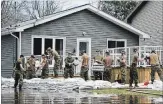  ?? SEAN KILPATRICK THE CANADIAN PRESS ?? Soldiers work to hold back floodwater­s on the Ottawa River in Cumberland, Ont., in April.