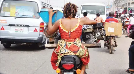  ?? Photo: Ikechukwu Ibe ?? Commercial cyclists manoeuvre through traffic at Mararaba in Nasarawa State yesterday