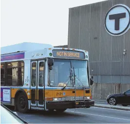  ?? STAFF PHOTO BY ANGELA ROWLINGS ?? PAY AS YOU GO: An out-of-service bus passes the MBTA’s Cabot Bus Facility in South Boston.