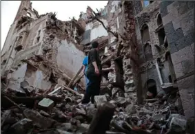  ?? (File Photo/AP/Hani Mohammed) ?? Yemeni people inspect a collapsed UNESCO-listed building Aug. 10 in the Old City of Sanaa, Yemen.