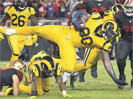  ?? Photograph­s by Wally Skalij Los Angeles Times ?? RAMS DEFENSIVE TACKLE Michael Brockers comes down with the intercepti­on after the 49ers’ two-point conversion is deflected on their final touchdown with 2:13 to play. The 49ers had to go for two because they had missed an extra point earlier.