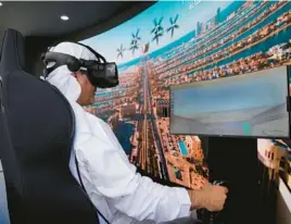  ?? KAMRAN JEBREILI/AP ?? A man experience­s a simulator of a flying taxi Monday at the Dubai Roads and Transporta­tion Authority’s stand during the World Government Summit in the UAE.