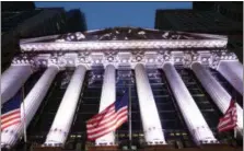  ?? MARK LENNIHAN — THE ASSOCIATED PRESS FILE ?? In this Wednesday file photo, American flags fly in front of the New York Stock Exchange. European shares rose on Monday despite a poor start for the week in Asia, where the Tokyo benchmark fell more than 3percent as investors registered their disappoint­ment over the lack of new stimulus from Japan’s central bank.