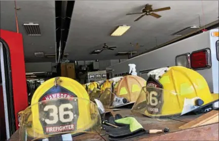 ?? DAVID S. GLASIER — THE NEWS-HERALD ?? Helmets arrayed in storage area at Hambden Township Volunteer Fire Department.