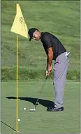  ?? DARRON CUMMINGS / AP ?? Tiger Woods putts on the 13th green Tuesday during a practice round for the Memorial in Dublin, Ohio.