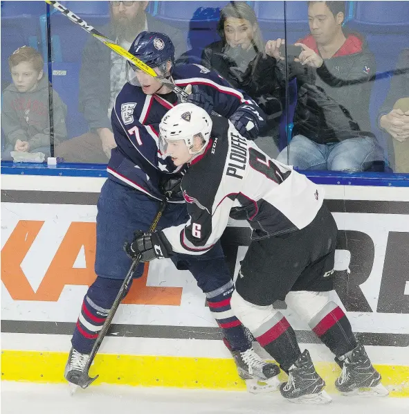  ?? MARK VAN MANEN/PNG FILES ?? Defenceman Dylan Plouffe, right, battling the Tri-City Americans’ Brendan O’Reilly during a Feb. 13 game at Langley Events Centre, made some strides this season on a Giants blue-line brigade missing leader Darian Skeoch for much of the season.