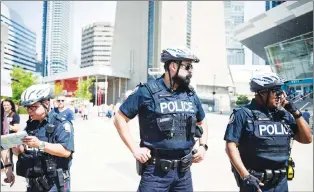  ?? CP PHOTO ?? Police are seen in Toronto, on Thursday.