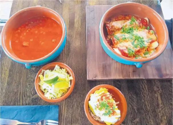  ?? RICHARD S. DARGAN/FOR THE JOURNAL ?? The Jealous Fork’s menu offers, clockwise from top right, beef brisket enchiladas with red chile and Menonita cheese, elote and posole.