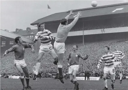  ??  ?? 0 Billy Mcneill leaps with Rangers keeper Norrie Martin in the 1969 Scottish Cup final as Alex Ferguson, centre, watches.