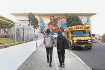  ?? Lea Suzuki / The Chronicle ?? Brothers Isaac (left) and Joshua Conde arrive at Thurgood Marshall Academic High just before S.F. schools closed.