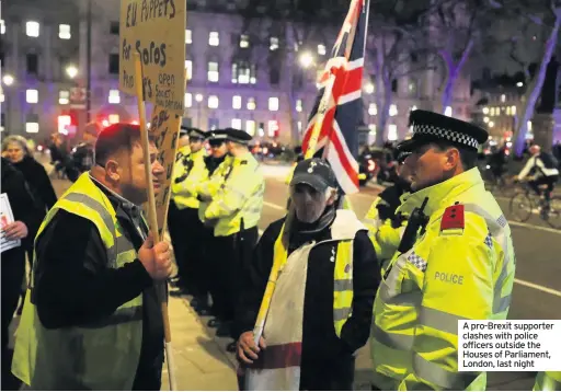  ??  ?? A pro-Brexit supporter clashes with police officers outside the Houses of Parliament, London, last night