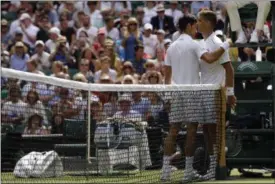  ?? ALASTAIR GRANT — ASSOCIATED PRESS ?? Novak Djokovic, left, embraces Martin Klizan after winning a men’s singles match on Day 2 at Wimbledon on July 4 in London.