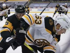  ?? Ap pHOTOS ?? DIGGING OUT: Penguins’ Brian Dumoulin, left, checks Bruins winger Brad Marchand on Monday night in Pittsburgh, Pa. Below, Penguins’ Evgeni Malkin (71) and Kaspari Kapenen (42) celebrate a goal by Evan Rodrigues past Bruins goaltender Jaroslav Halak.