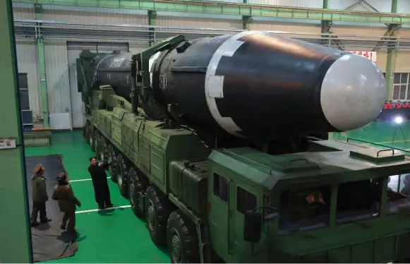  ?? KOREA NEWS SERVICE VIA THE ASSOCIATED PRESS ?? This Wednesday image provided by the North Korean government shows leader Kim Jong Un with an interconti­nental ballistic missile that may be capable of reaching the United States.