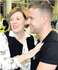  ??  ?? Welcome home Jamie and mum Patricia face the press on his arrival at Glasgow Airport