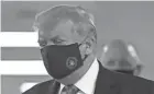  ?? PATRICK SEMANSKY/AP ?? President Donald Trump on Saturday for the first time was seen in public with a facial covering recommende­d by health officials.