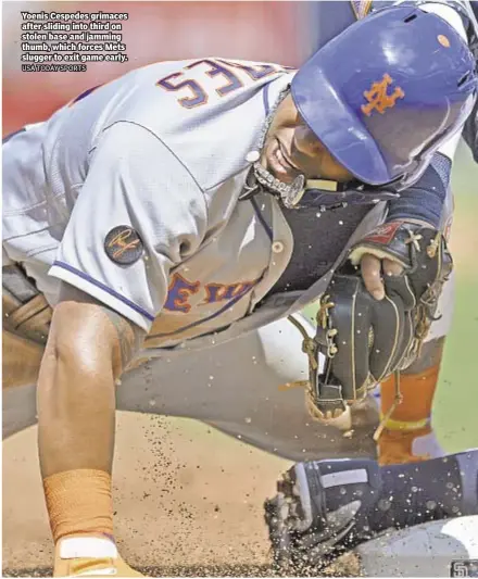  ?? USA TODAY SPORTS ?? Yoenis Cespedes grimaces after sliding into third on stolen base and jamming thumb, which forces Mets slugger to exit game early.