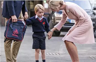  ??  ?? First day: Prince George is welcomed to Thomas’s London Day School