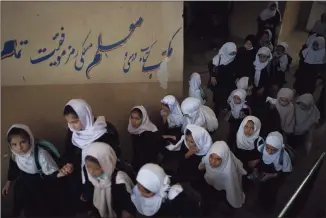  ?? Felipe Dana / Associated Press ?? Girls walk upstairs as they enter a school before class in Kabul, Afghanista­n, on Sunday.
