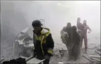  ?? PICTURE: AP ?? Members of the Syrian Civil Defence group the White Helmets help residents during shelling by Syrian government forces in Ghouta.