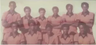  ?? ?? Slow Poison... Justus (far right - kneeling), proudly attired in the gorgeous orange and black strip of the Okakarara Senior Secondary School football team, aka ‘Ozohakane’ (Wild Dogs). Back row from left: Gotty Kavezepa, Five Kandingua, Jackson Meroro, Moses Mbai, Nduki Tjazerua, Muinjoo Kotjipati. Front row from left: Ephraim Mate (d+), Sam Marenga, Jakunua Jezurura, Kavejaa ‘Louw’ Tjiho (capt - d+), Justus Tjikarerer­a Tjejamba (d+).